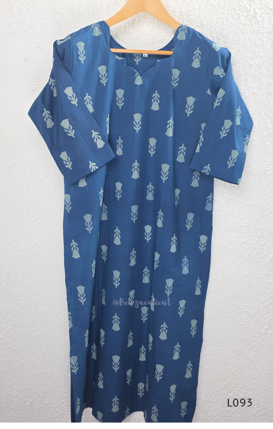 Blue cotton women’s top with light leaf print, notch neckline, elbow-length sleeves, and straight everyday fit.