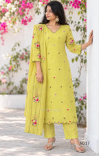 yellow Mul Chanderi three-piece churidar sets with floral embroidery, scalloped kurta hems and cuffs, plain pants and matching dupattas.