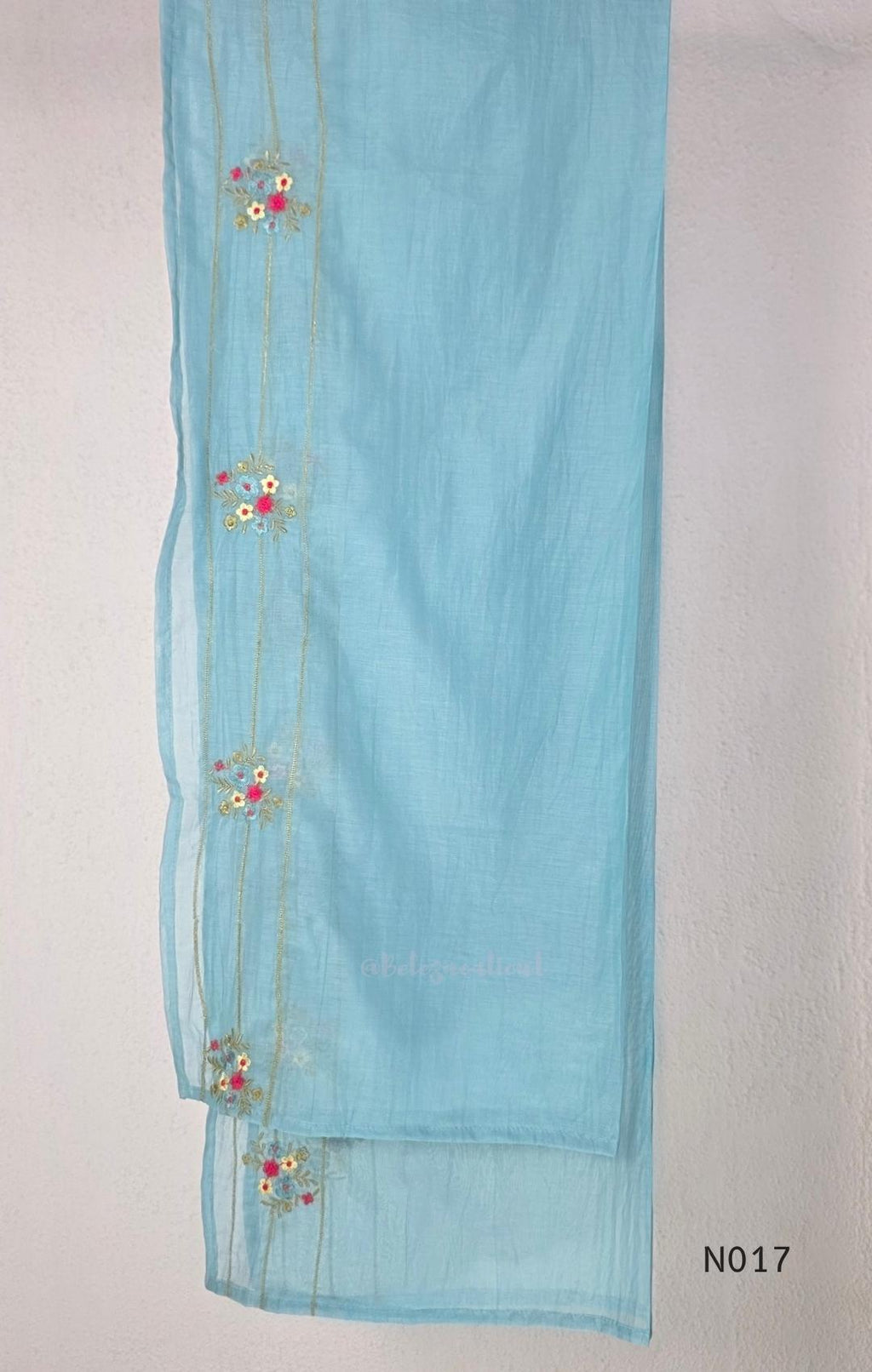 Aqua blue  Mul Chanderi three-piece churidar sets with floral embroidery, scalloped kurta hems and cuffs, plain pants and matching dupattas.