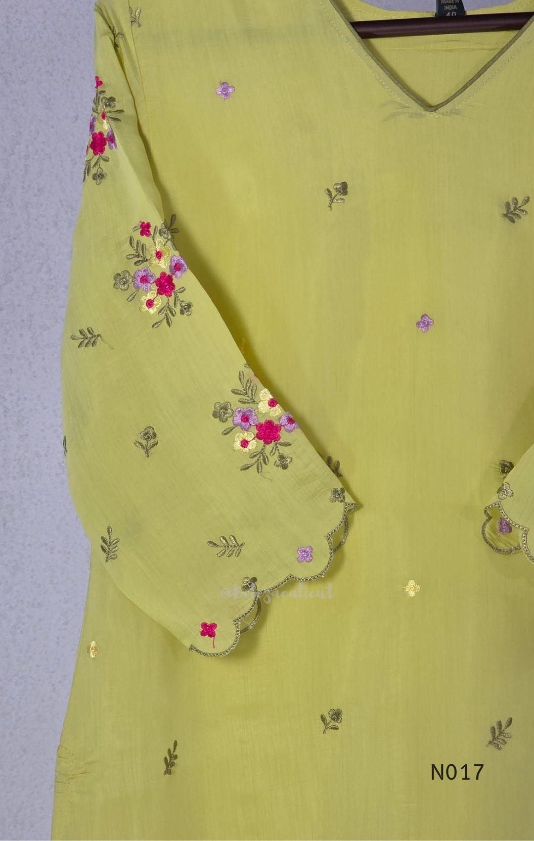 yellow Mul Chanderi three-piece churidar sets with floral embroidery, scalloped kurta hems and cuffs, plain pants and matching dupattas.