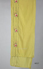 yellow Mul Chanderi three-piece churidar sets with floral embroidery, scalloped kurta hems and cuffs, plain pants and matching dupattas.
