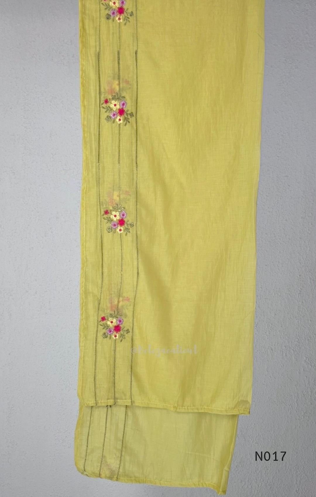 yellow Mul Chanderi three-piece churidar sets with floral embroidery, scalloped kurta hems and cuffs, plain pants and matching dupattas.