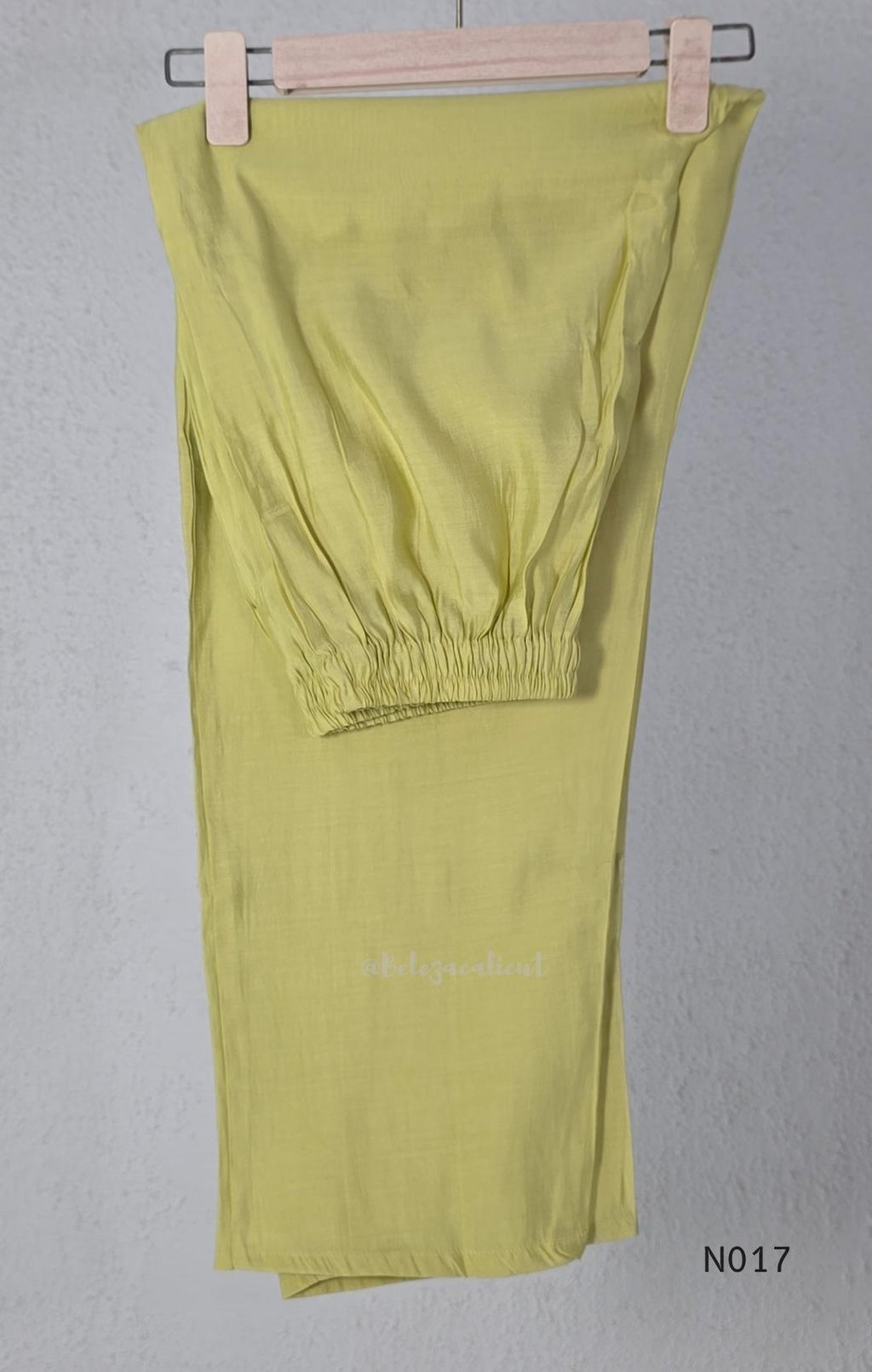 yellow Mul Chanderi three-piece churidar sets with floral embroidery, scalloped kurta hems and cuffs, plain pants and matching dupattas.