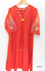 Bright orange cotton plus size churidar set with tassel V-neck, embroidered sleeve detail, matching bottom and dupatta.