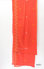 Bright orange cotton plus size churidar set with tassel V-neck, embroidered sleeve detail, matching bottom and dupatta.