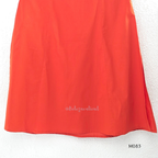 Bright orange cotton plus size churidar set with tassel V-neck, embroidered sleeve detail, matching bottom and dupatta.