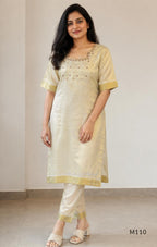 Champagne gold tissue silk 2-piece set with embellished neckline, elbow sleeves, straight kurta and matching bottom.