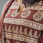Chocolate brown Jaipur cotton 3-piece churidar set with cream horizontal band block print, mandala circular motifs, V-notch neckline, A-line flared kurti with 3/4 sleeves and border hem, matching block print dupatta, Indian ethnic wear from Beleza Calicut