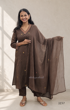 Coffee brown mul cotton churidar set with lining, floral embroidery, dupatta and scallop neckline. Available at Beleza Calicut.