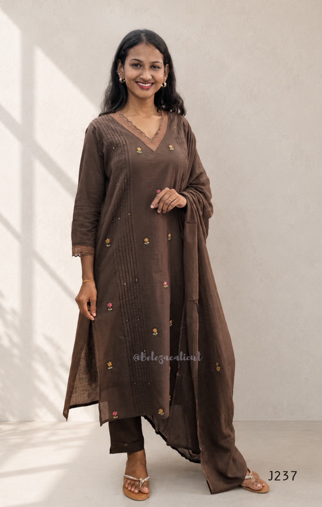 Coffee brown mul cotton churidar set with lining, floral embroidery, dupatta and scallop neckline. Available at Beleza Calicut.