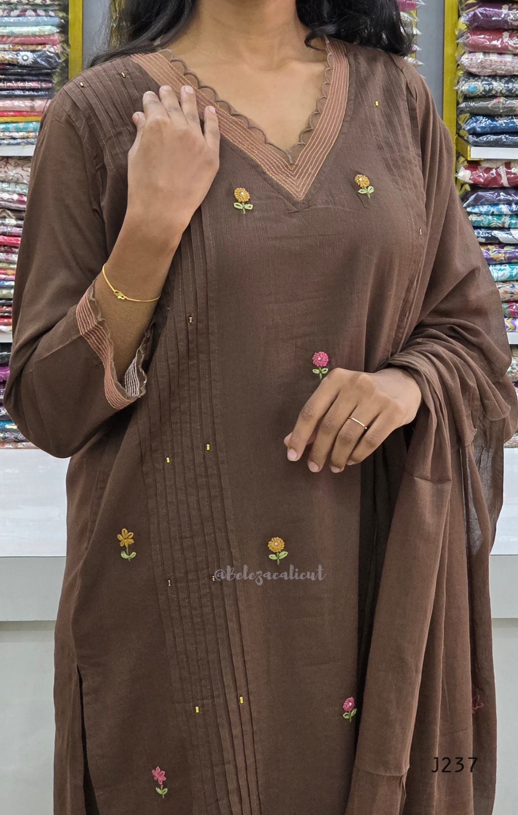 Coffee brown mul cotton churidar set with lining, floral embroidery, dupatta and scallop neckline. Available at Beleza Calicut.
