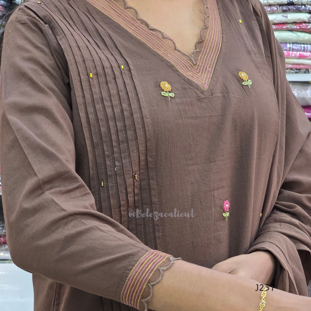 Coffee brown mul cotton churidar set with lining, floral embroidery, dupatta and scallop neckline. Available at Beleza Calicut.