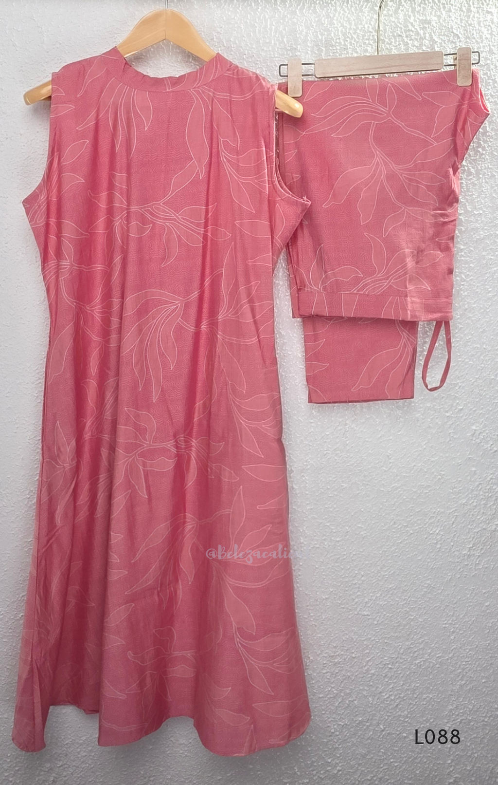 Coral pink rayon blend 2-piece set with white leaf line print, high neck top, back zip and matching printed straight pant.