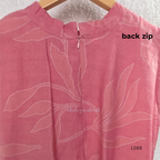 Coral pink rayon blend 2-piece set with white leaf line print, high neck top, back zip and matching printed straight pant.