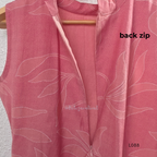 Coral pink rayon blend 2-piece set with white leaf line print, high neck top, back zip and matching printed straight pant.