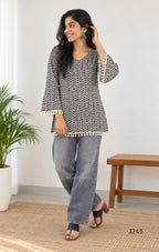 Cream cotton printed short top with bell sleeves and tassel edging, sold as a top only.