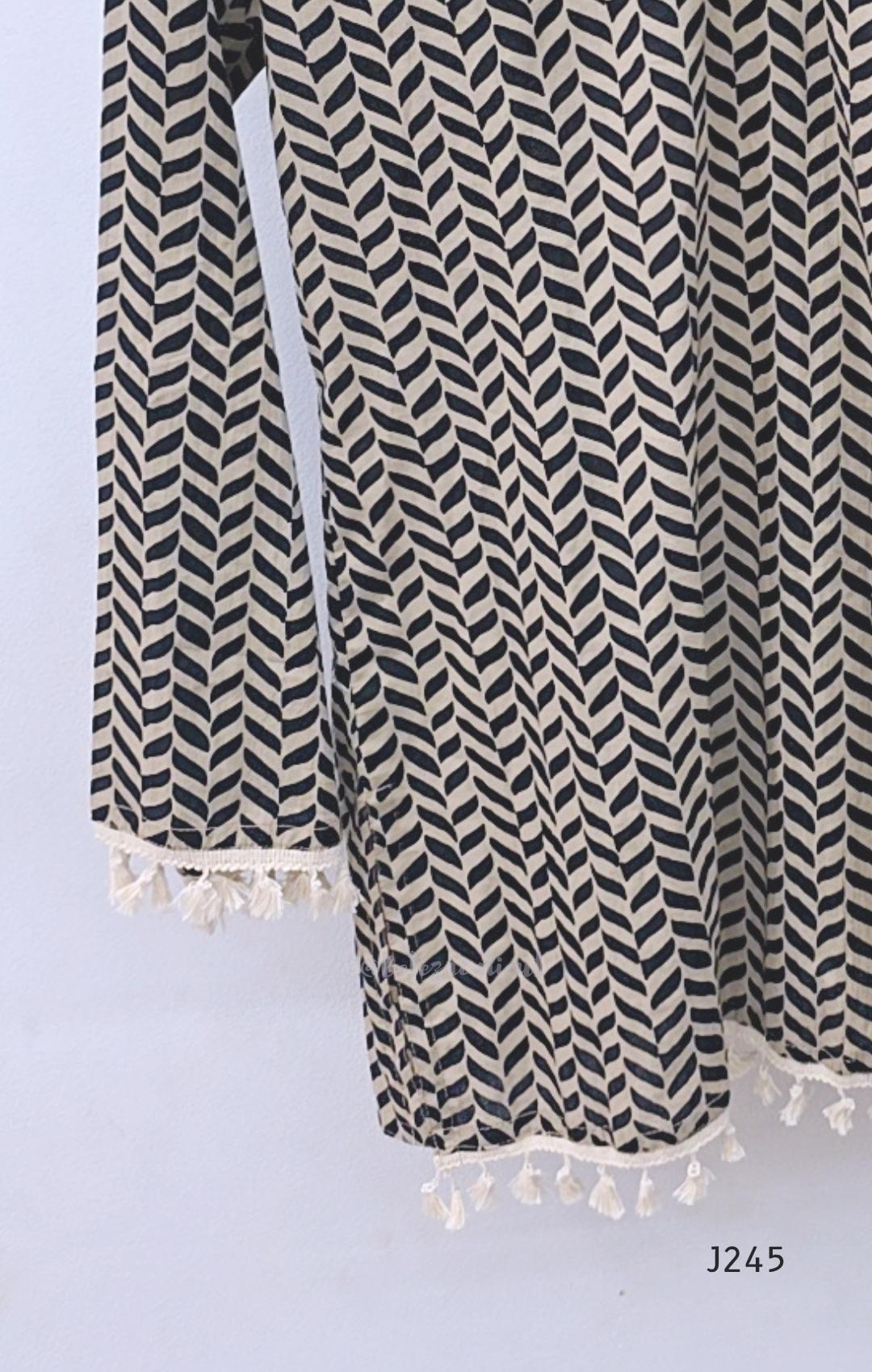 Cream cotton printed short top with bell sleeves and tassel edging, sold as a top only.