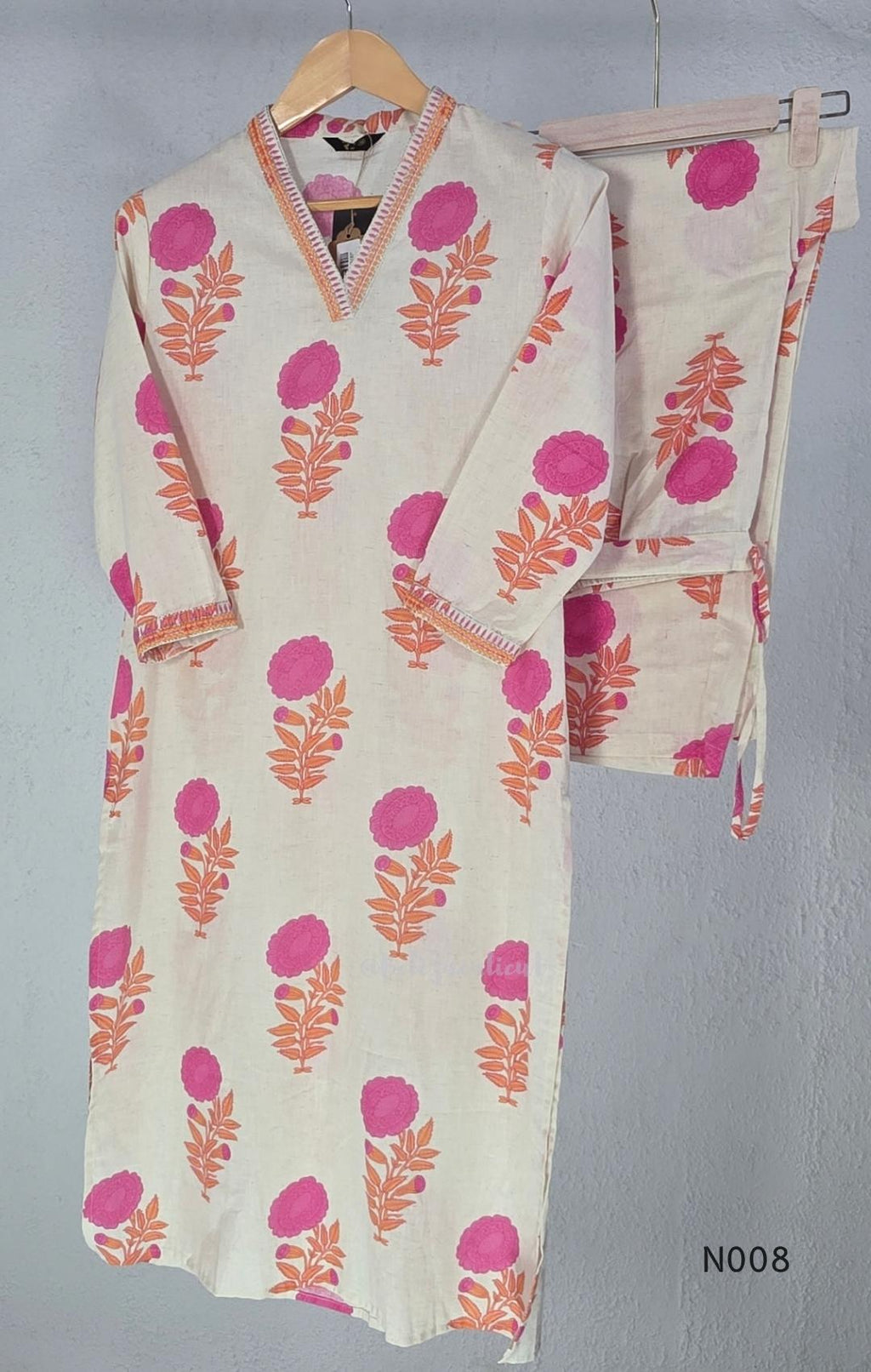 Cream flex cotton top and straight-pant co-ord set with bright pink and orange floral motifs and decorative neckline trim.