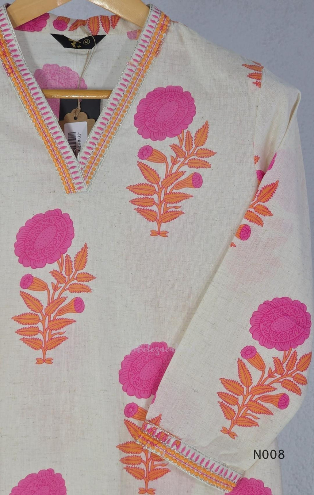 Cream flex cotton top and straight-pant co-ord set with bright pink and orange floral motifs and decorative neckline trim.