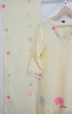 Cream mul cotton churidar set with lining, pastel pink and powder blue floral embroidery, matching dupatta, 3/4 sleeves and V-neck bead detail 