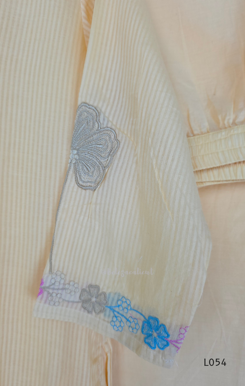 Cream mul cotton churidar set with lining, pastel pink and powder blue floral embroidery, matching dupatta, 3/4 sleeves and V-neck bead detail 