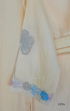 Cream mul cotton churidar set with lining, pastel pink and powder blue floral embroidery, matching dupatta, 3/4 sleeves and V-neck bead detail 