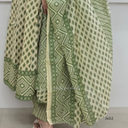 Green and white patterned fabric draped over a person against a white background