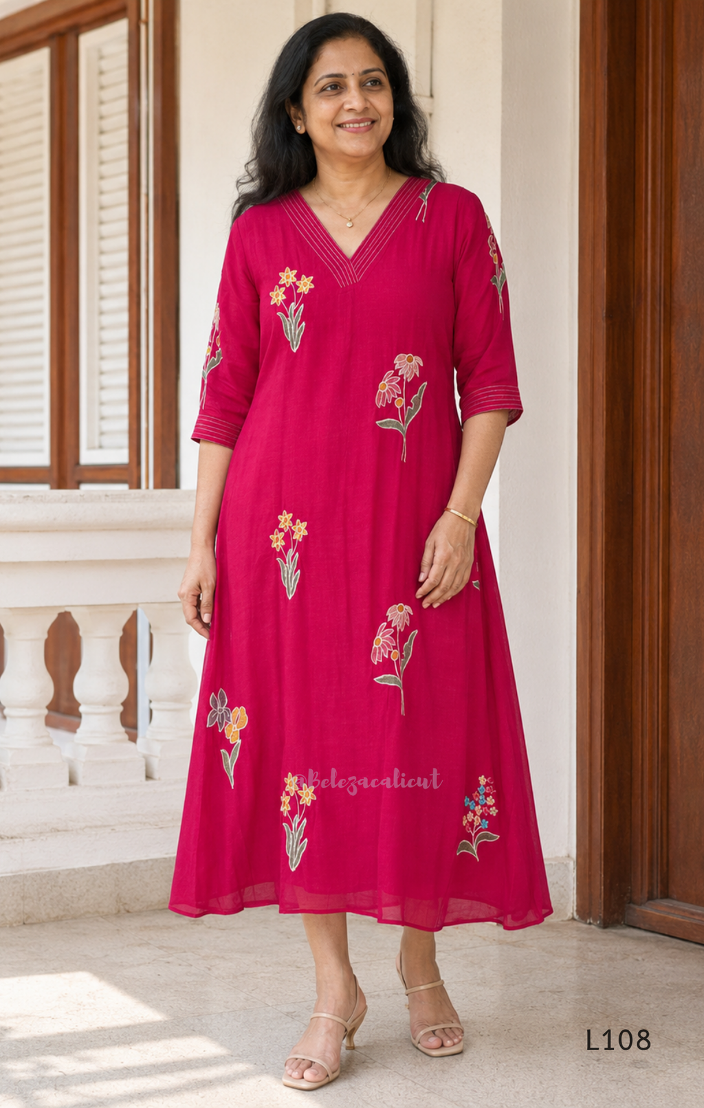 Deep magenta mul chanderi A-line kurti with colourful floral embroidery, V-neck stitch detail and 3/4 sleeves