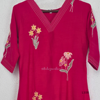 Deep magenta mul chanderi A-line kurti with colourful floral embroidery, V-neck stitch detail and 3/4 sleeves