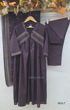 Deep plum cotton churidar suit set with matching bottom and dupatta, mirror detail V-neckline, gold line work on yoke, and elegant festive casual styling.
