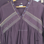 Deep plum cotton churidar suit set with matching bottom and dupatta, mirror detail V-neckline, gold line work on yoke, and elegant festive casual styling.