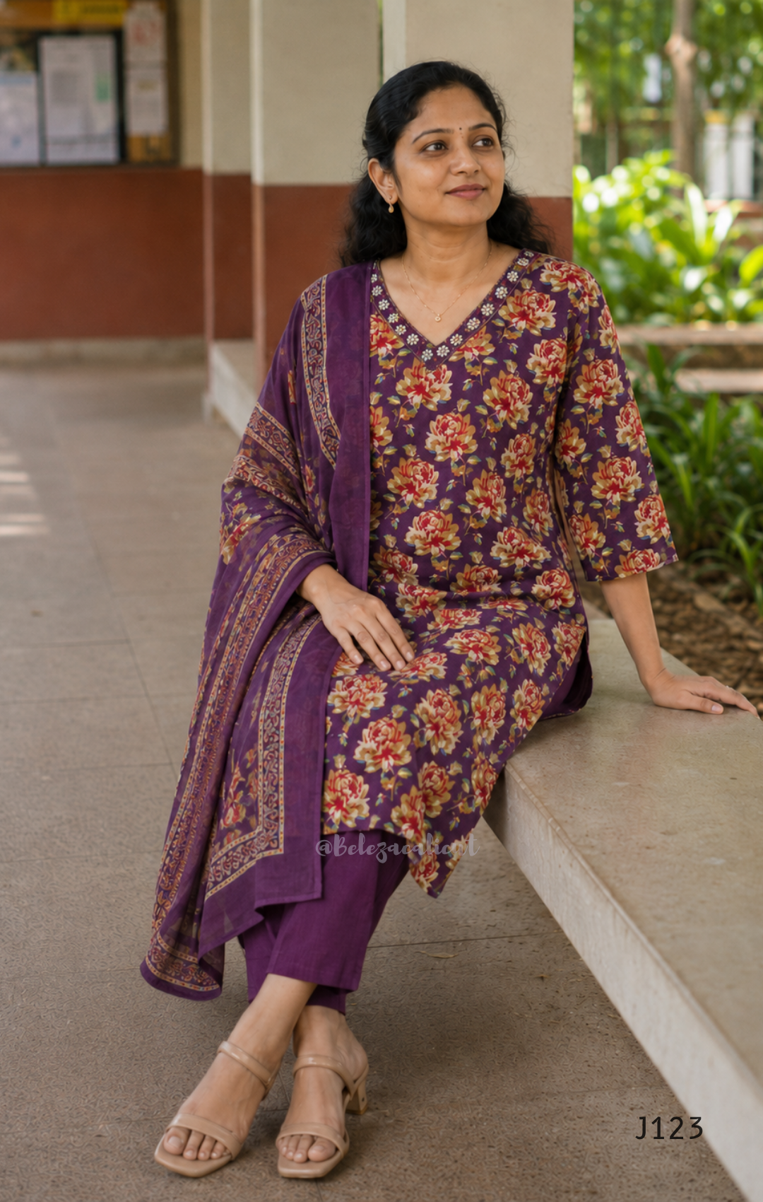 Deep purple cotton churidar set with rose floral print, matching dupatta, 3/4 sleeves, and embellished V-neckline displayed on mannequin.