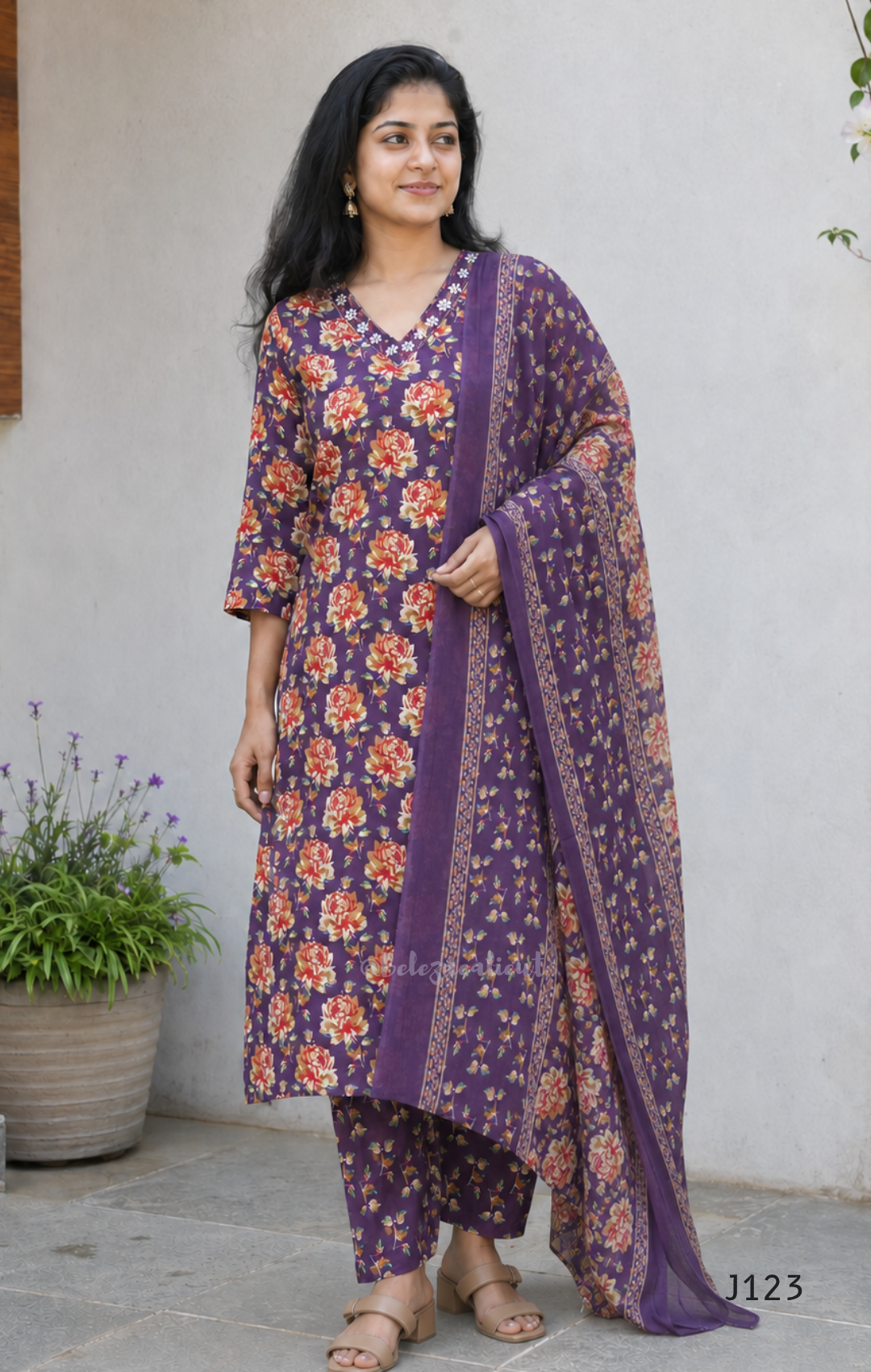 Purple Jaipur cotton churidar set with floral print, V-neck detail, matching printed bottom and dupatta.