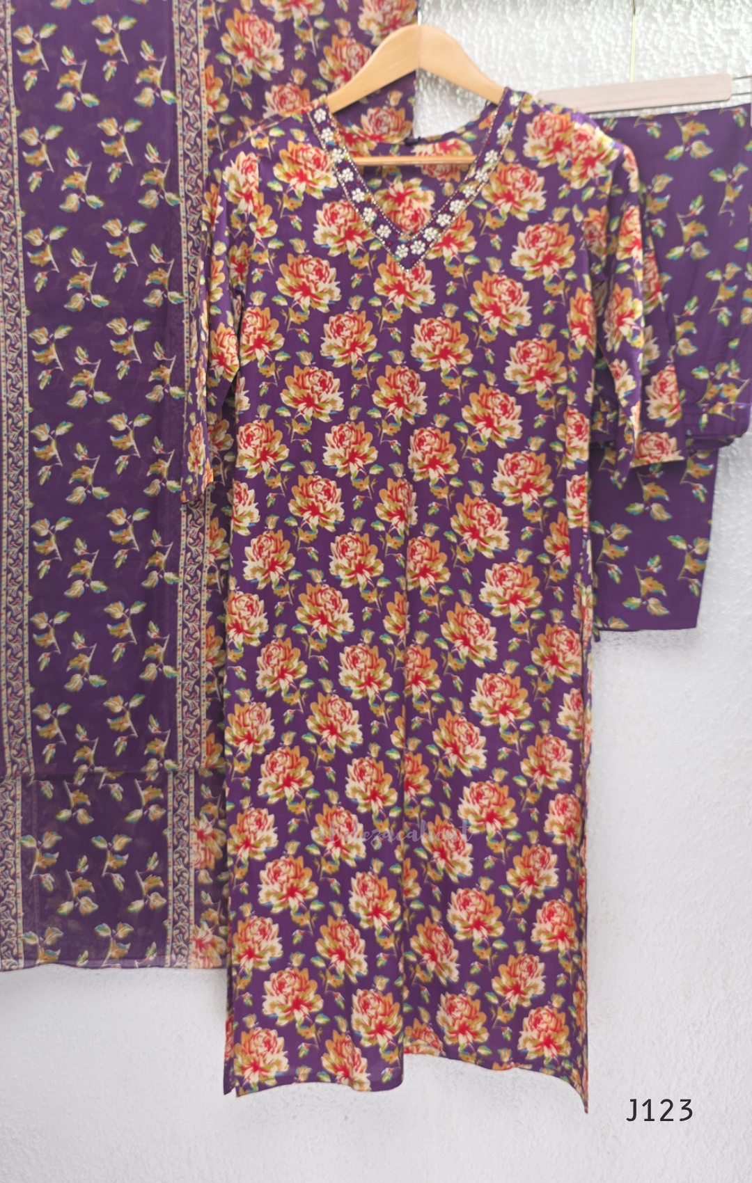 Purple Jaipur cotton churidar set with floral print, V-neck detail, matching printed bottom and dupatta.