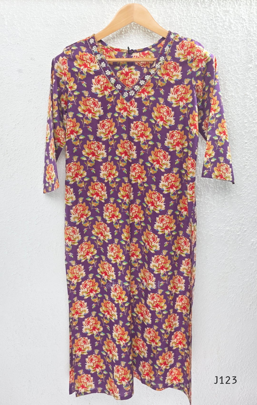 Purple Jaipur cotton churidar set with floral print, V-neck detail, matching printed bottom and dupatta.