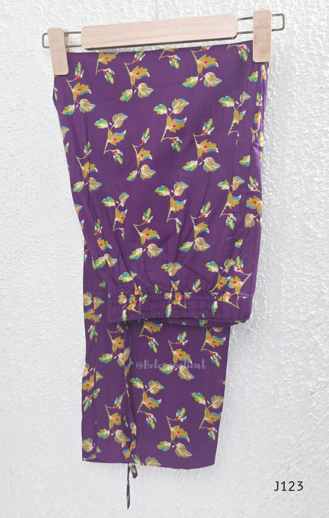 Purple Jaipur cotton churidar set with floral print, V-neck detail, matching printed bottom and dupatta.