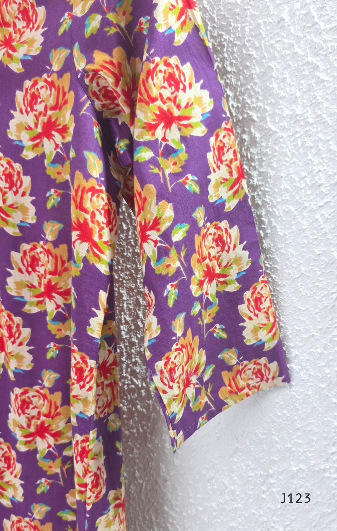 Purple Jaipur cotton churidar set with floral print, V-neck detail, matching printed bottom and dupatta.