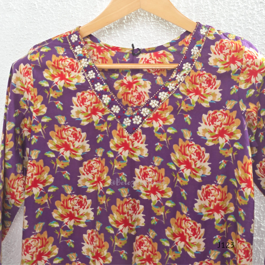 Purple Jaipur cotton churidar set with floral print, V-neck detail, matching printed bottom and dupatta.