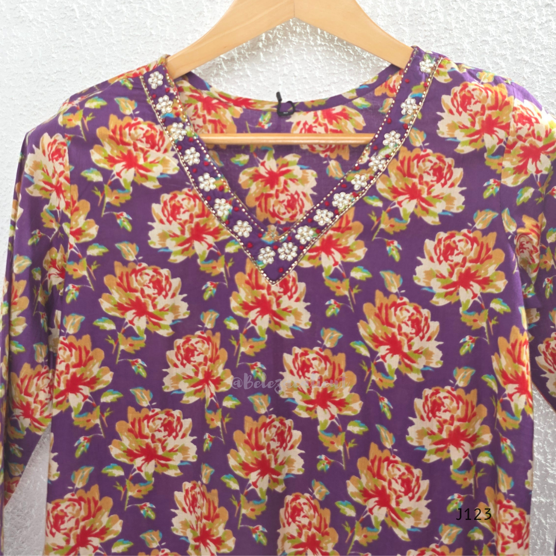 Purple Jaipur cotton churidar set with floral print, V-neck detail, matching printed bottom and dupatta.