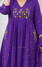 Purple cotton 3-piece churidar set with yellow floral embroidery, V-neck, matching dupatta and plain bottom.