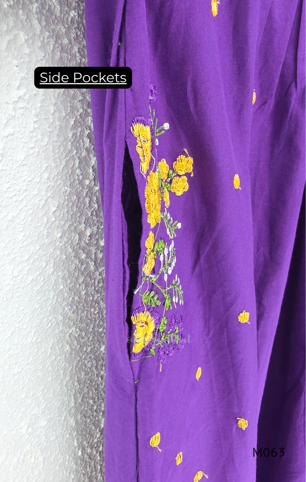 Purple cotton 3-piece churidar set with yellow floral embroidery, V-neck, matching dupatta and plain bottom.