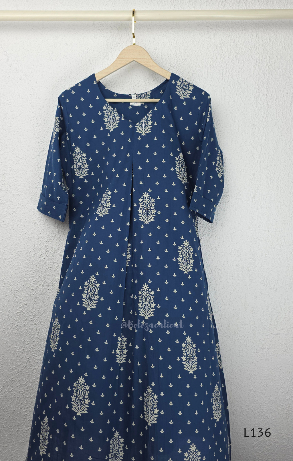 Dusty blue cotton kurta top with white floral buti print, centre pleat detail, 3/4 sleeves, and relaxed A-line fit.