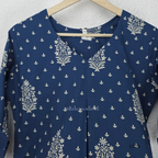 Dusty blue cotton kurta top with white floral buti print, centre pleat detail, 3/4 sleeves, and relaxed A-line fit.