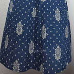 Dusty blue cotton kurta top with white floral buti print, centre pleat detail, 3/4 sleeves, and relaxed A-line fit.