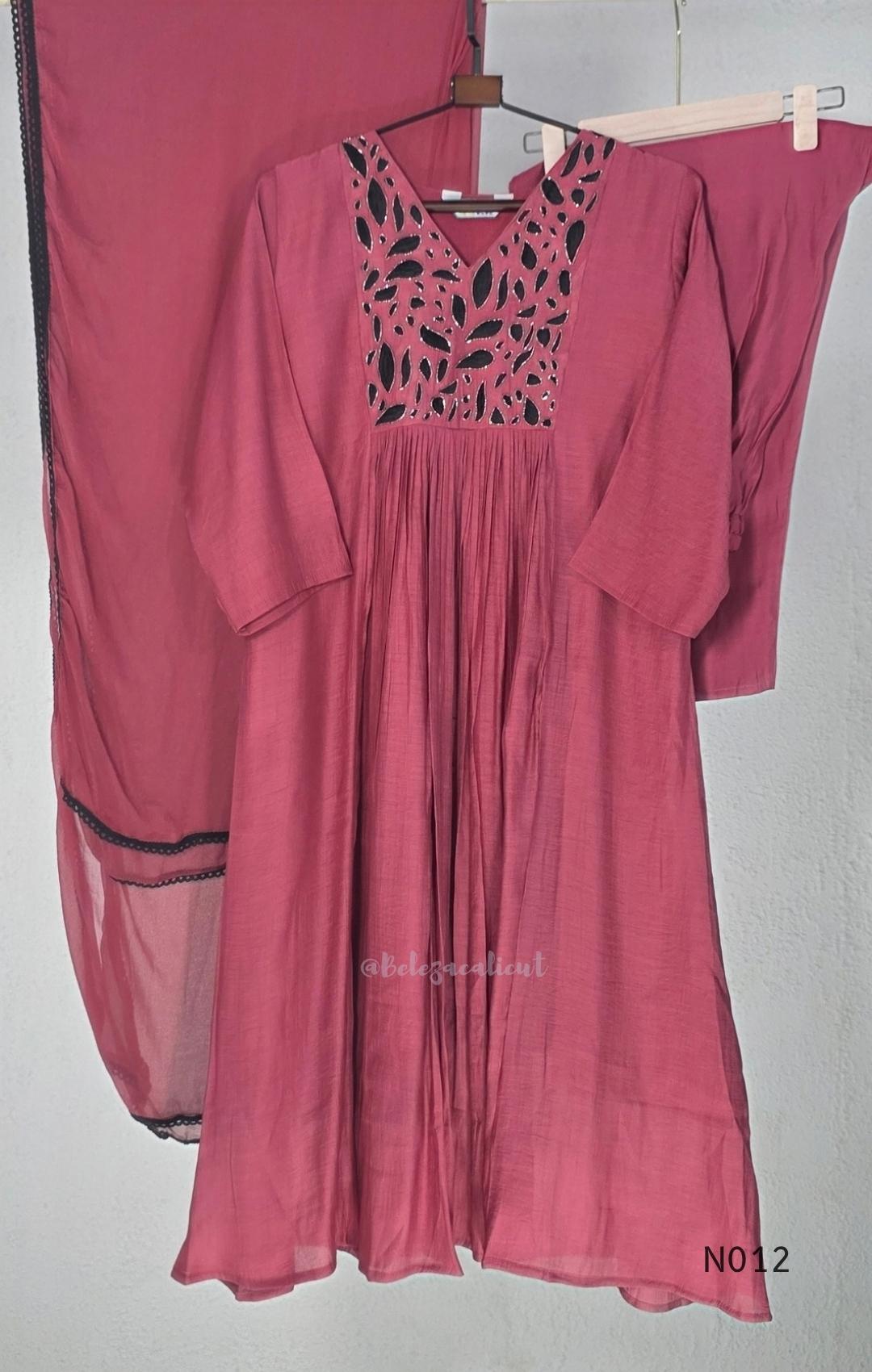 Dusty rose pink Mul Chanderi full churidar set with black leaf-shaped neckline work, matching straight pants and chiffon dupatta.