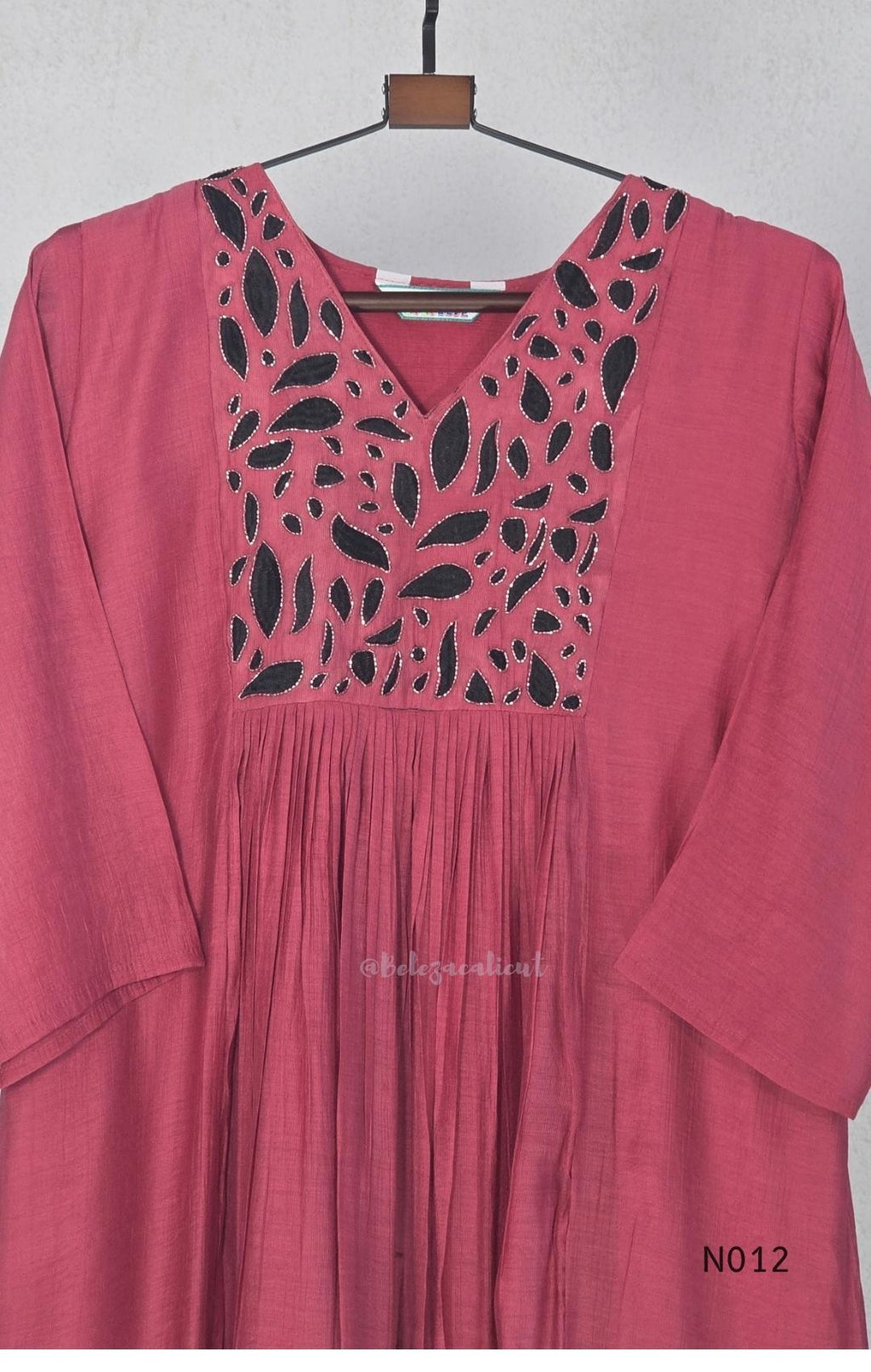 Dusty rose pink Mul Chanderi full churidar set with black leaf-shaped neckline work, matching straight pants and chiffon dupatta.