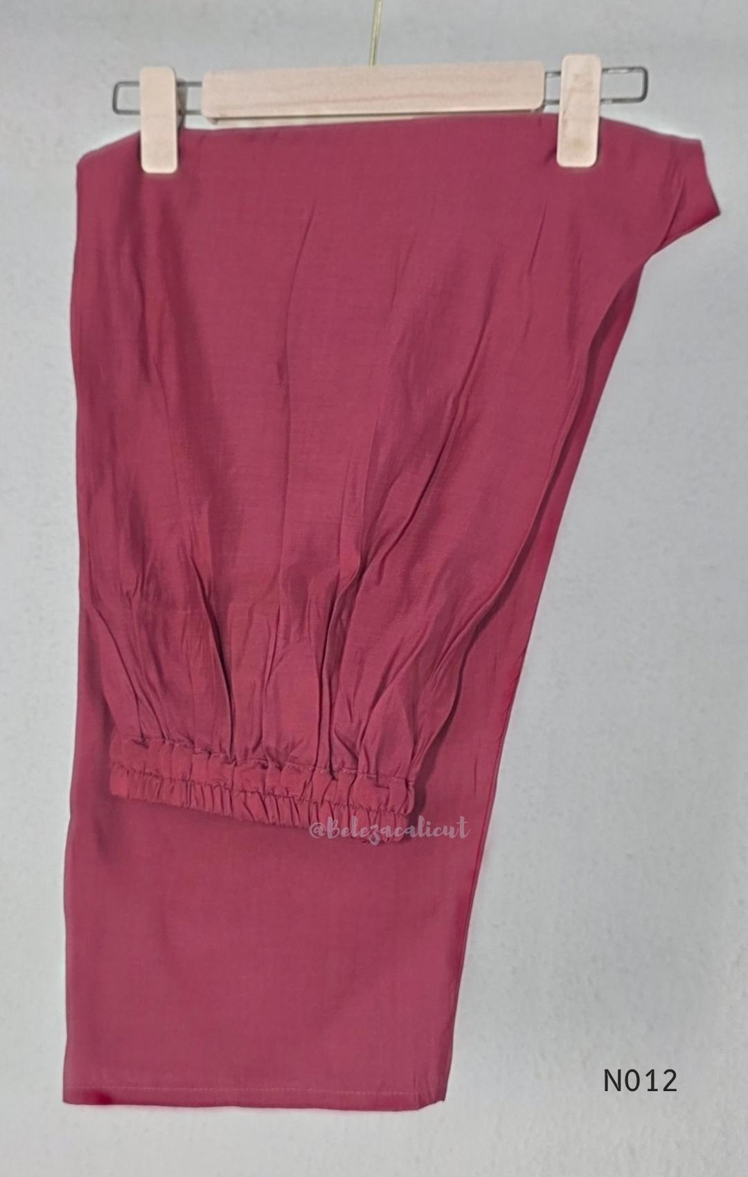 Dusty rose pink Mul Chanderi full churidar set with black leaf-shaped neckline work, matching straight pants and chiffon dupatta.