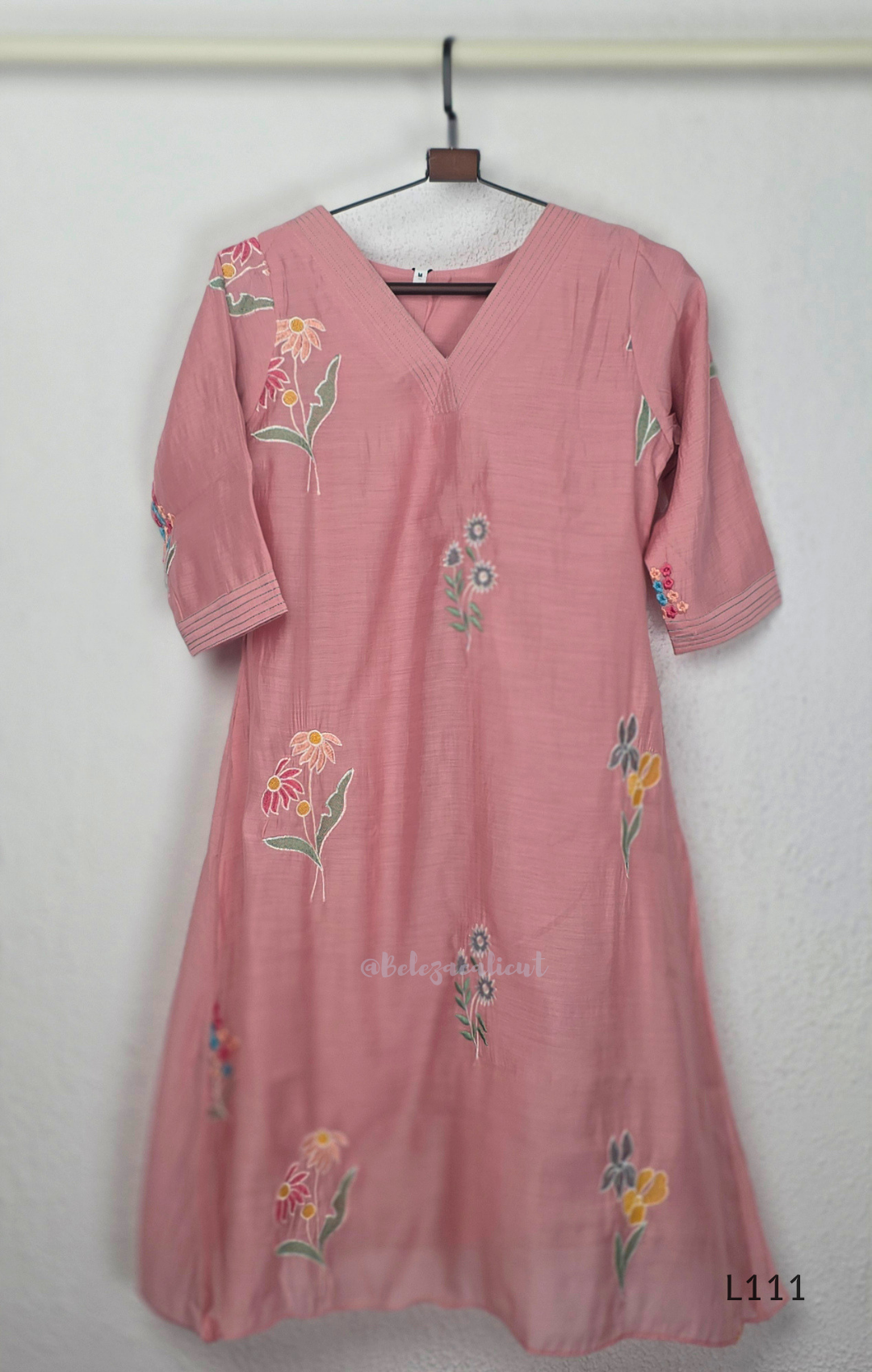 Dusty rose pink mul chanderi A-line kurti with scattered floral embroidery, V-neck stitch detail and 3/4 sleeves