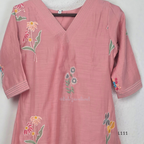 Dusty rose pink mul chanderi A-line kurti with scattered floral embroidery, V-neck stitch detail and 3/4 sleeves