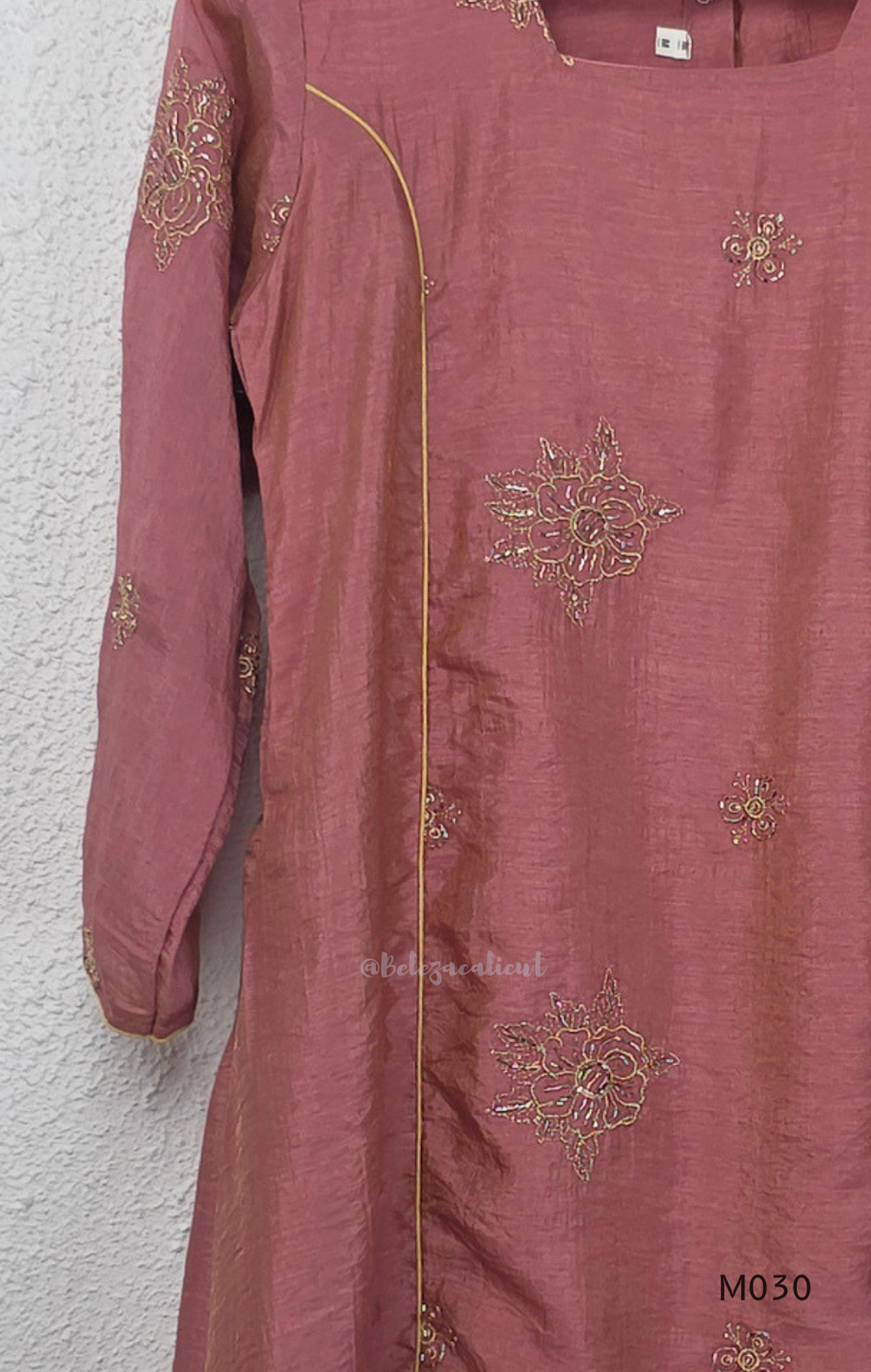 Dusty rose 2-piece kurti set with gold floral motifs, gold piping detail, matching bottom, 3/4 sleeves, and relaxed flared fit.